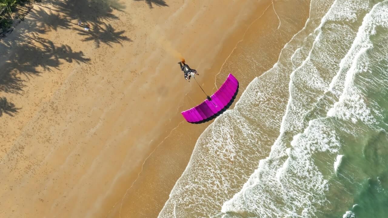 view above leia swooping beach with waves and palm trees