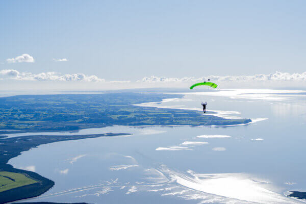 Skydiver flying a Safire 4 canopy over Lake Taupō.