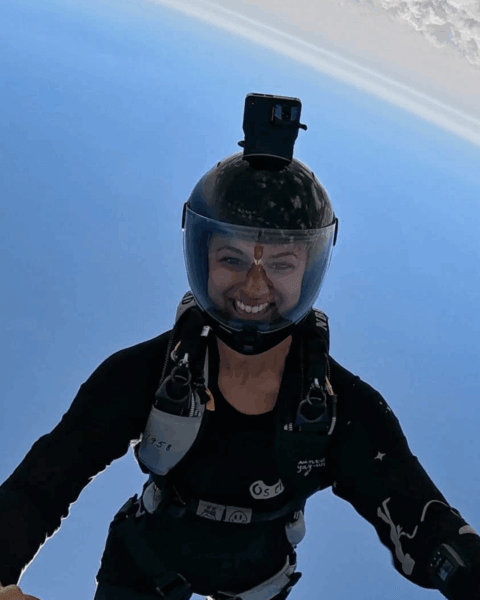 Leah grrining head down during skydive